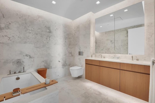 bathroom with toilet, vanity, tile walls, and a bathing tub