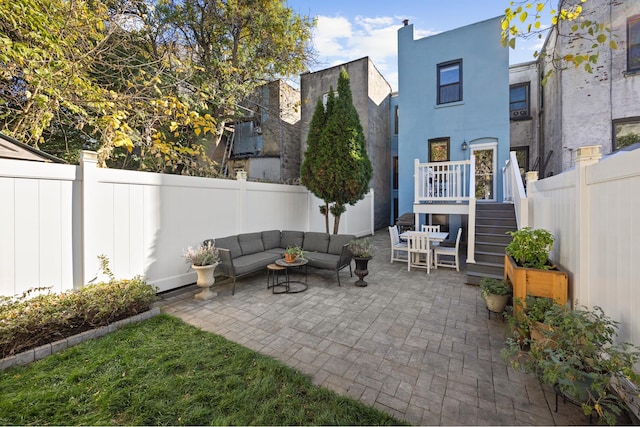 view of patio featuring an outdoor hangout area and a fenced backyard