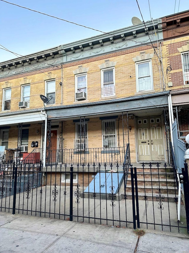 229 Nichols Ave, New York City, NY 11208 - view of property featuring brick siding, a porch, and a fenced front yard