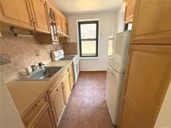 kitchen with tasteful backsplash, white appliances, light countertops, and a sink