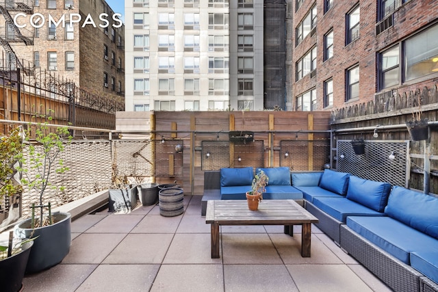 view of patio featuring an outdoor hangout area and fence