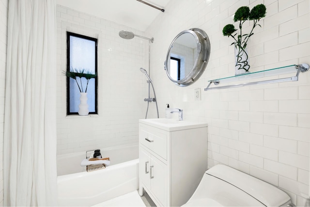 bathroom with tile walls, shower / tub combo, vanity, and toilet