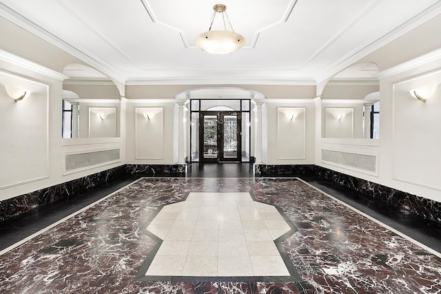entryway with marble tiled floors, inlaid floor details, ornate columns, a decorative wall, and arched walkways