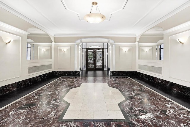 entryway with marble tiled floors, inlaid floor details, a decorative wall, ornate columns, and arched walkways