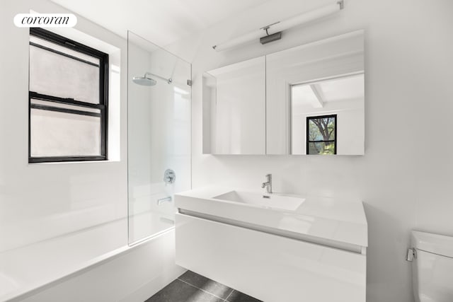 full bathroom with toilet, vanity, tile patterned floors, and  shower combination