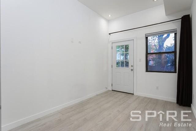 foyer entrance with light wood-type flooring