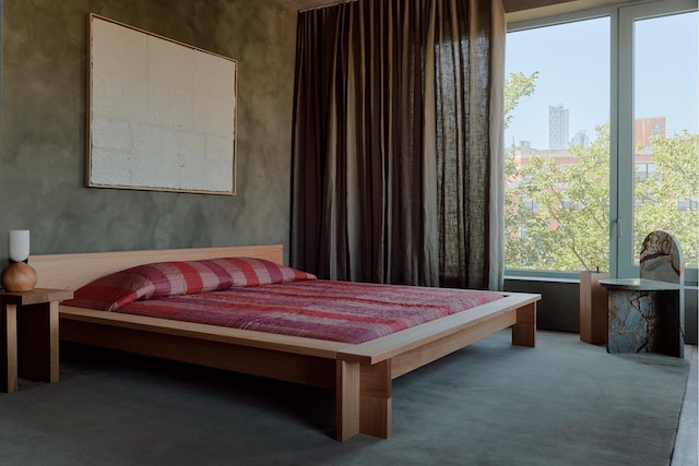 bedroom with carpet and a city view