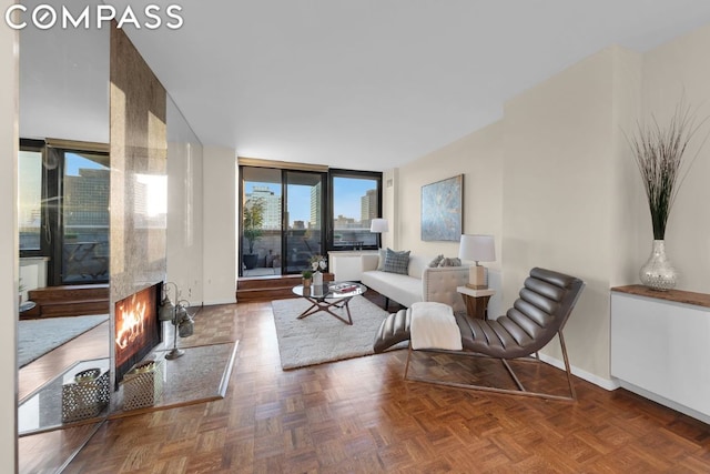 living room with expansive windows and parquet flooring