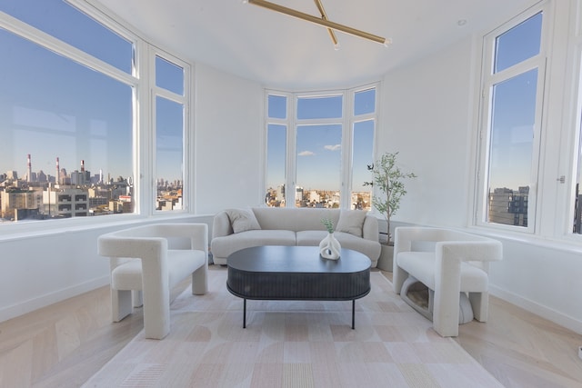 living area with baseboards and a city view