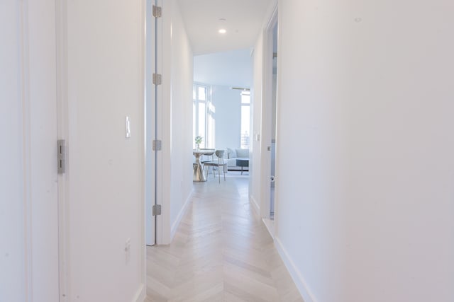 corridor featuring recessed lighting and baseboards