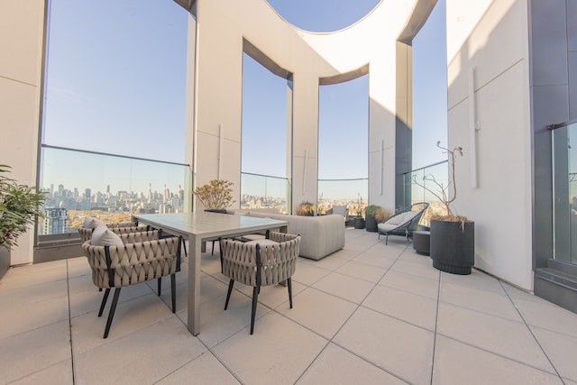 view of patio / terrace featuring outdoor dining area and a city view