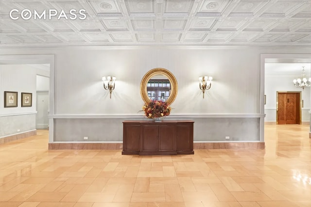 interior space featuring an ornate ceiling, baseboards, and an inviting chandelier