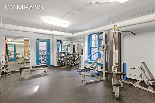 gym featuring a wealth of natural light and baseboards