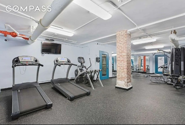 exercise room featuring decorative columns