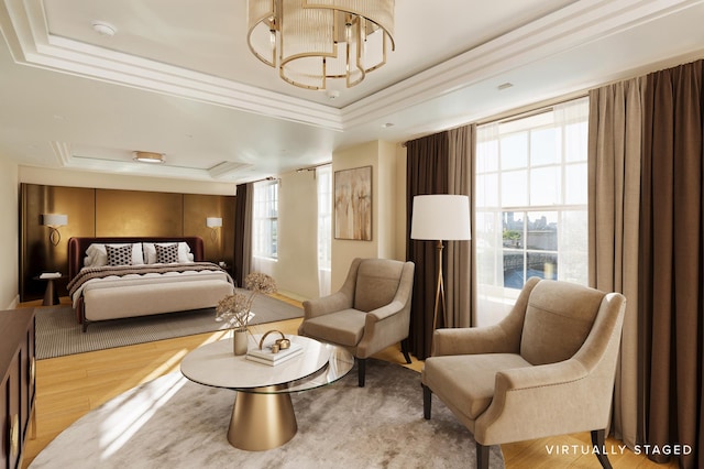 bedroom featuring a raised ceiling, wood finished floors, and a chandelier