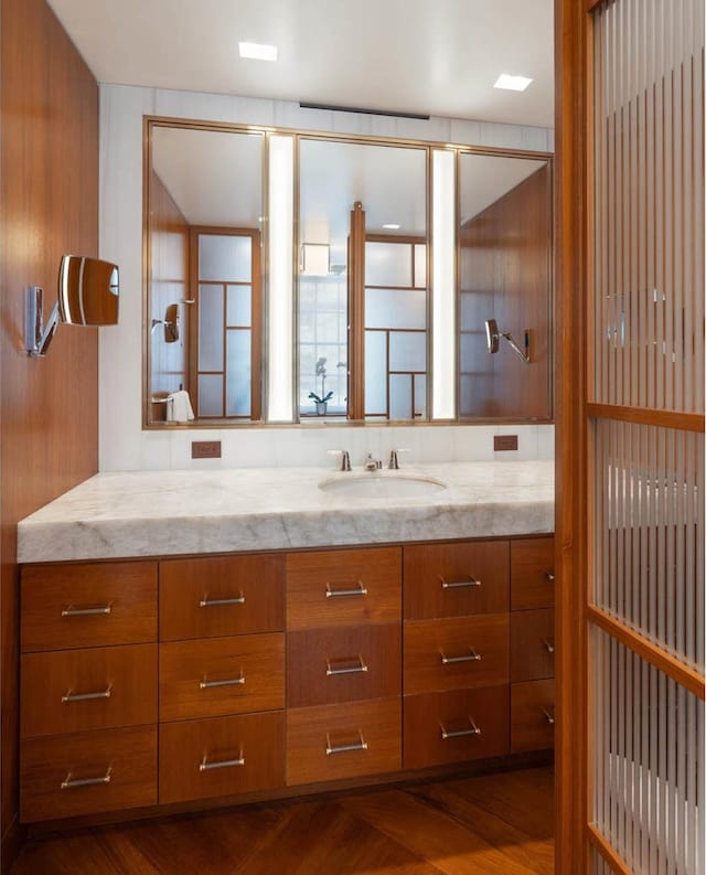 bathroom with vanity and wood finished floors