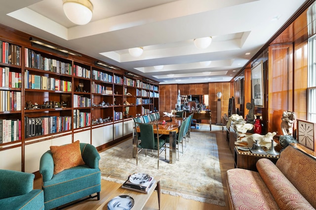 interior space featuring a raised ceiling, wood finished floors, and healthy amount of natural light
