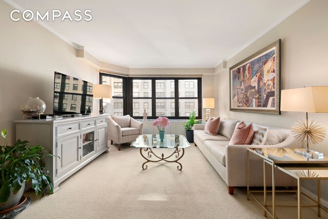 living area featuring light colored carpet and crown molding