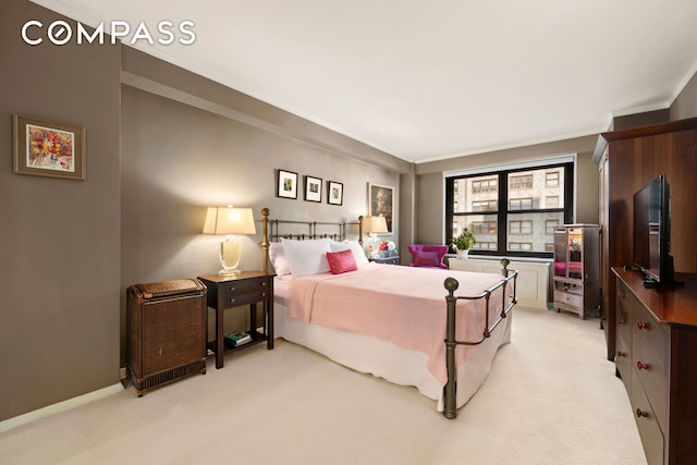 bedroom with ornamental molding, baseboards, and light carpet