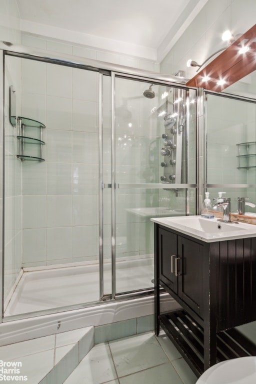 bathroom featuring vanity and a shower with shower door