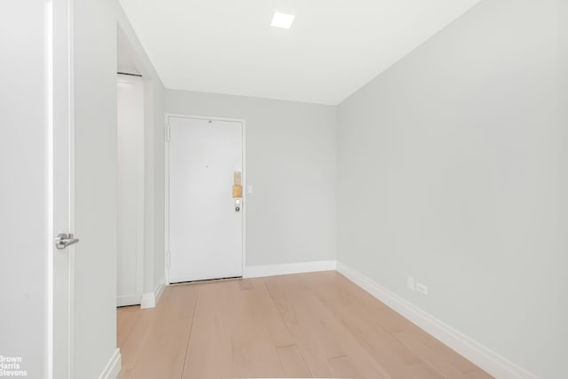 unfurnished room featuring light wood-style floors and baseboards