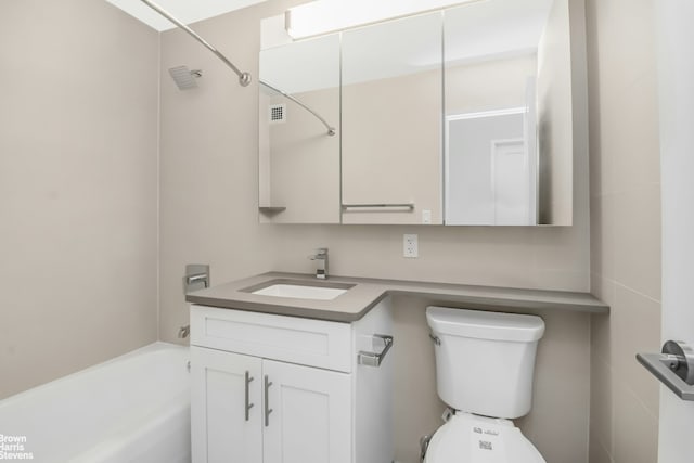 full bath with visible vents, toilet, vanity, and a tub