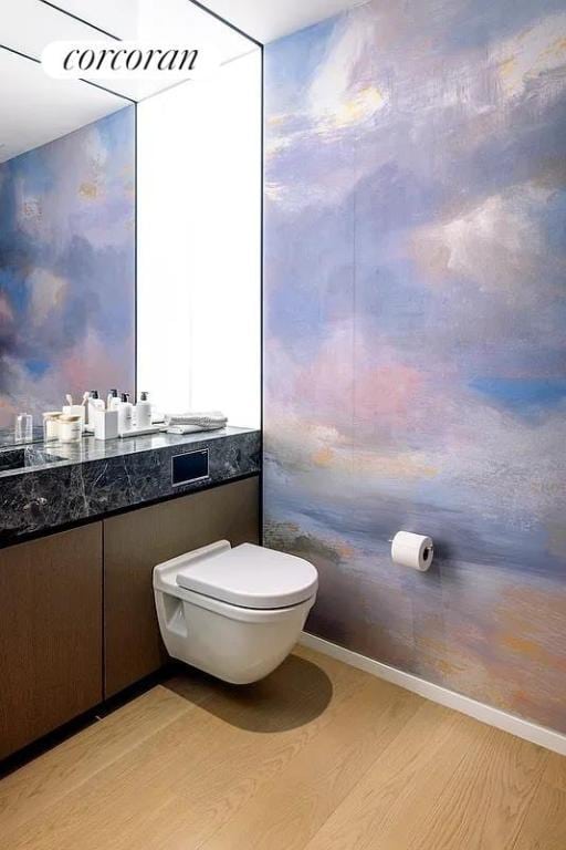 bathroom with hardwood / wood-style flooring, vanity, and toilet