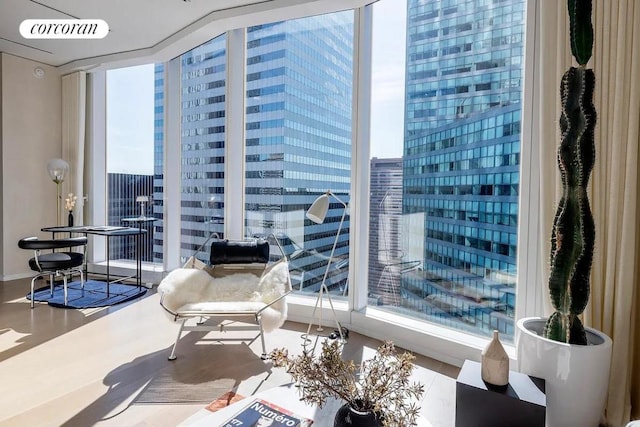 sitting room with floor to ceiling windows and hardwood / wood-style floors