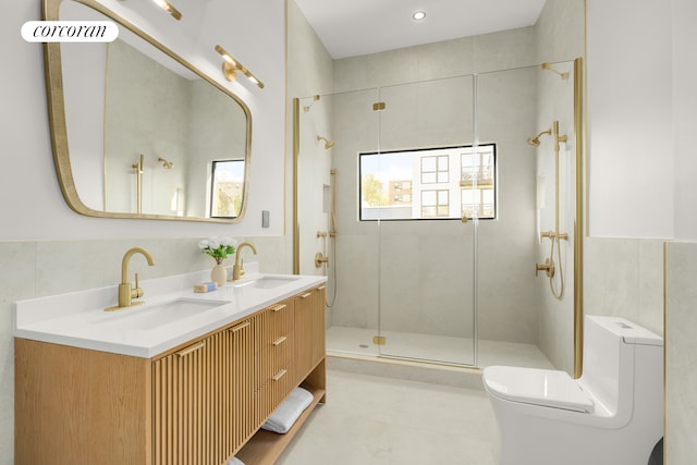 bathroom featuring double vanity, a sink, toilet, and a shower stall