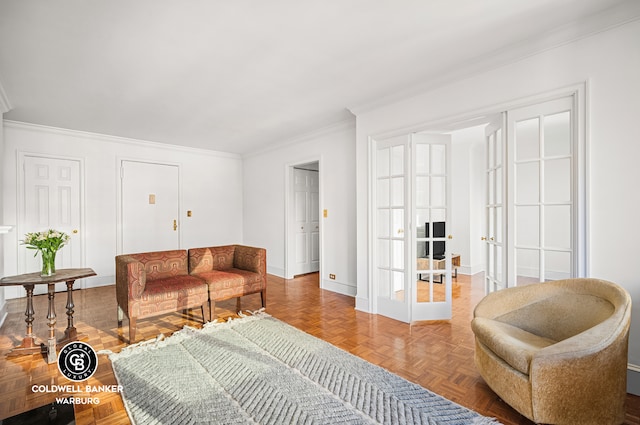 living area with baseboards, crown molding, and french doors