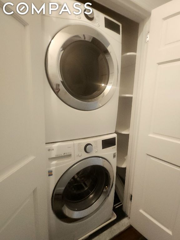 laundry area with stacked washer / dryer