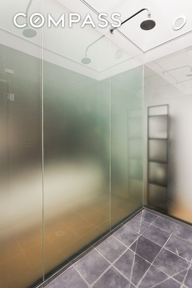 interior space featuring a shower and tile patterned floors