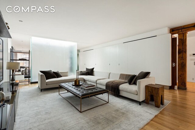 living room featuring light hardwood / wood-style flooring and floor to ceiling windows