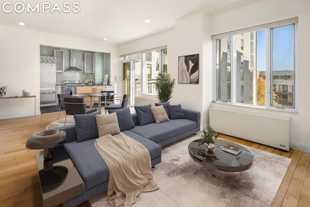 living room with light hardwood / wood-style flooring and radiator heating unit