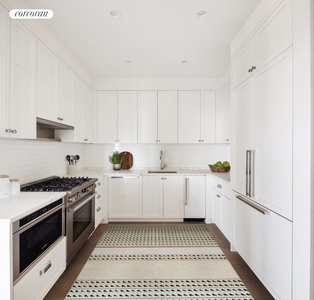 100 Claremont Ave Unit 35C, New York City, NY 10027 - kitchen featuring premium appliances, white cabinets, decorative backsplash, and recessed lighting