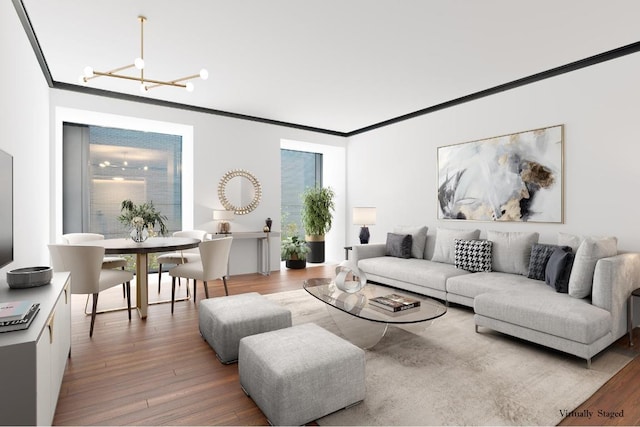 living room featuring an inviting chandelier, ornamental molding, and light hardwood / wood-style floors