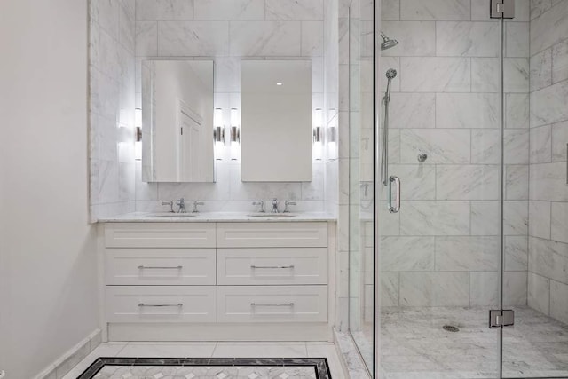 full bath featuring a shower stall, double vanity, and a sink