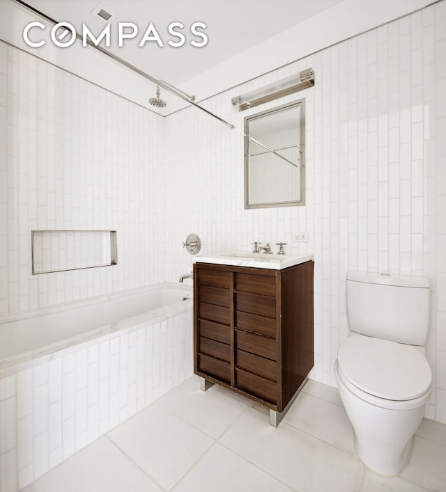 151 E 85th St Unit 14A, New York City, NY 10028 - full bath featuring tiled shower / bath, vanity, tile walls, tile patterned floors, and toilet