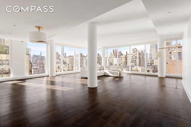 151 E 85th St Unit 14A, New York City, NY 10028 - gym featuring a view of skyline and dark wood-style floors