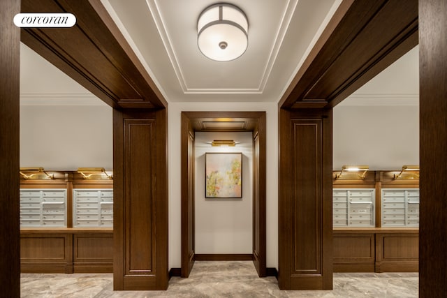hallway with mail area and baseboards