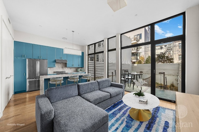 living room featuring floor to ceiling windows and hardwood / wood-style floors