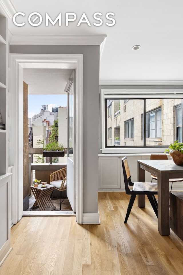 entryway with light wood-type flooring and ornamental molding