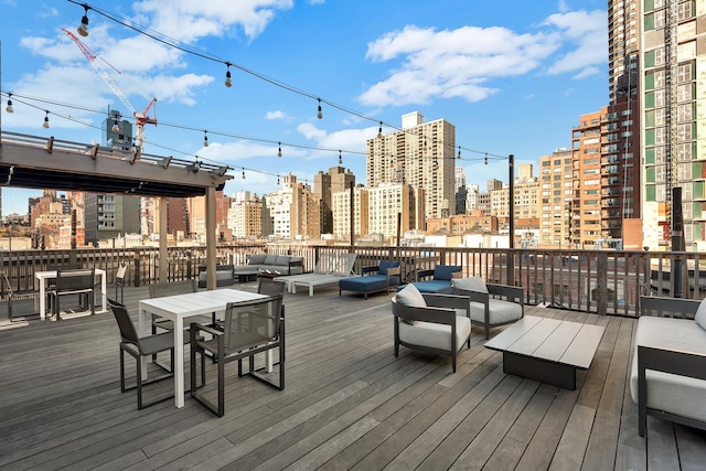 deck featuring a view of city and an outdoor living space