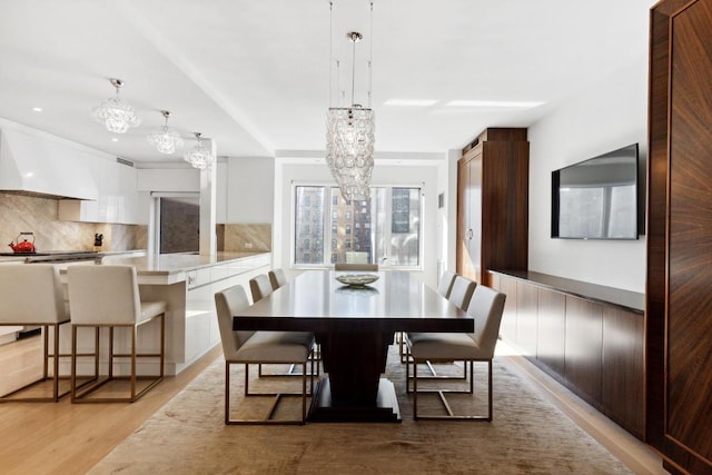 dining room with a notable chandelier and light hardwood / wood-style floors