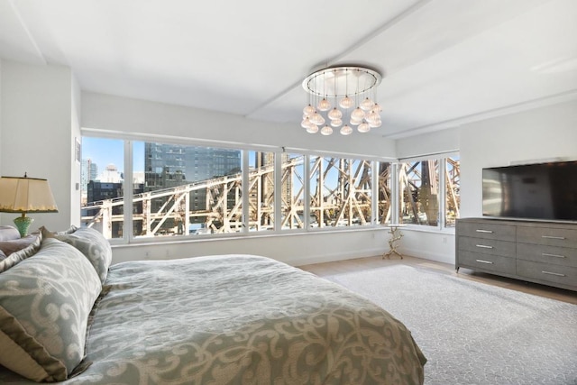 bedroom featuring multiple windows and a notable chandelier