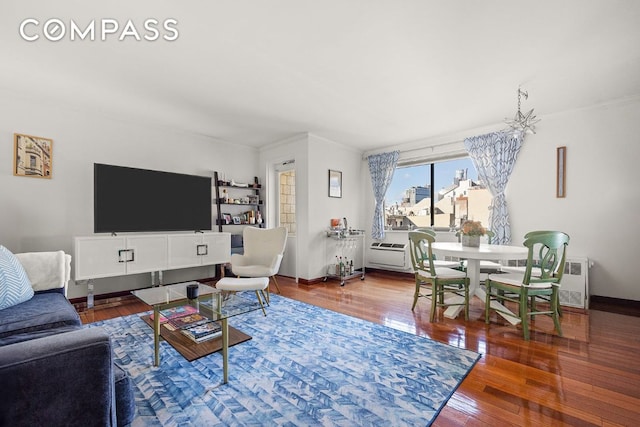 living room featuring hardwood / wood-style flooring and crown molding