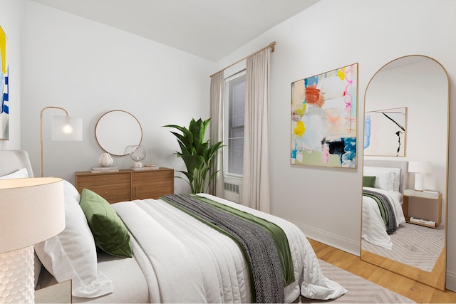 bedroom with light wood-style floors and baseboards