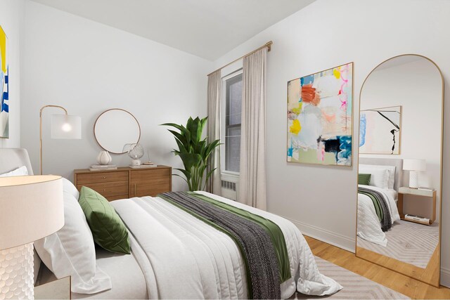 bedroom featuring baseboards, wood finished floors, and lofted ceiling