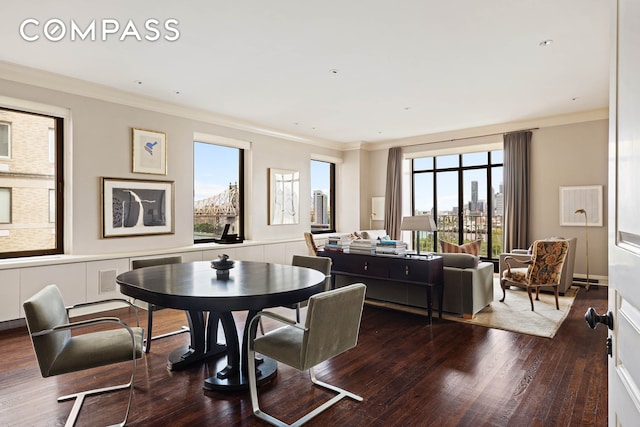 dining area with a city view, dark wood-style flooring, and ornamental molding