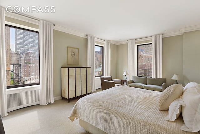 bedroom with multiple windows, crown molding, radiator heating unit, and carpet floors